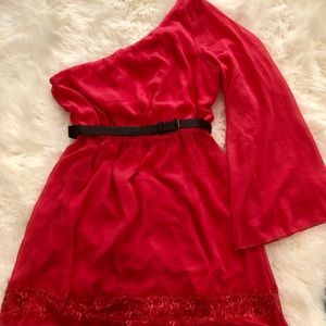 Coral. Short, one shoulder dress with belt.